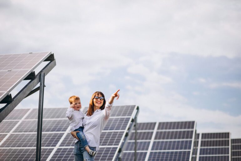 Mulher com criança no colo satisfeita ao contratar uma empresa de energia solar